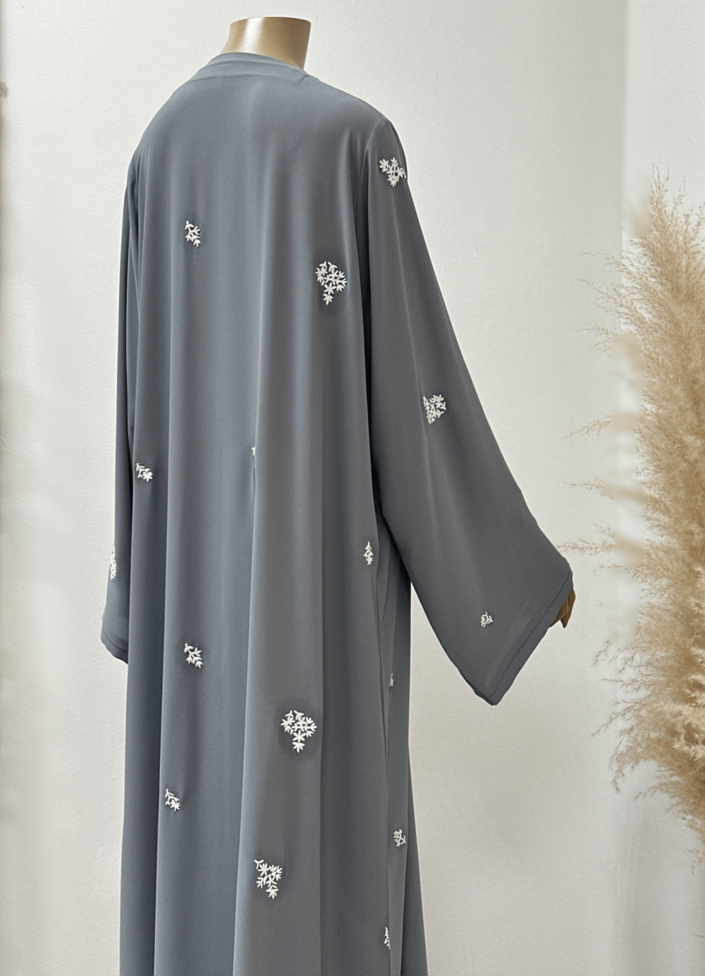 "Back view of the Egyptian Crape Abaya by Alishbah, featuring a lightweight and elegantly draped design. The abaya falls gracefully, highlighting its refined silhouette and luxurious fabric. Ideal for any occasion, this piece combines comfort with timeless style