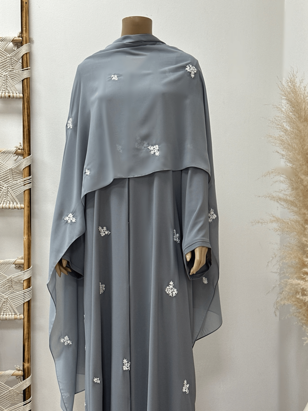 "Front view of the Egyptian Crape Abaya by Alishbah, with the Sheila fully open and draped elegantly over the abaya. The lightweight fabric creates a graceful, flowing silhouette, showcasing the full length and delicate details of the design. The Sheila complements the abaya, enhancing its sophisticated look."