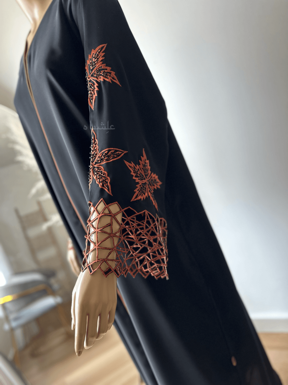 Abaya made from luxurious Nida fabric featuring intricate cutwork embroidery on the sleeves and handwork embellishments on the front panel. The Alishbah Nida Premium Abaya combines elegance and sophistication, offering timeless grace for any occasion.