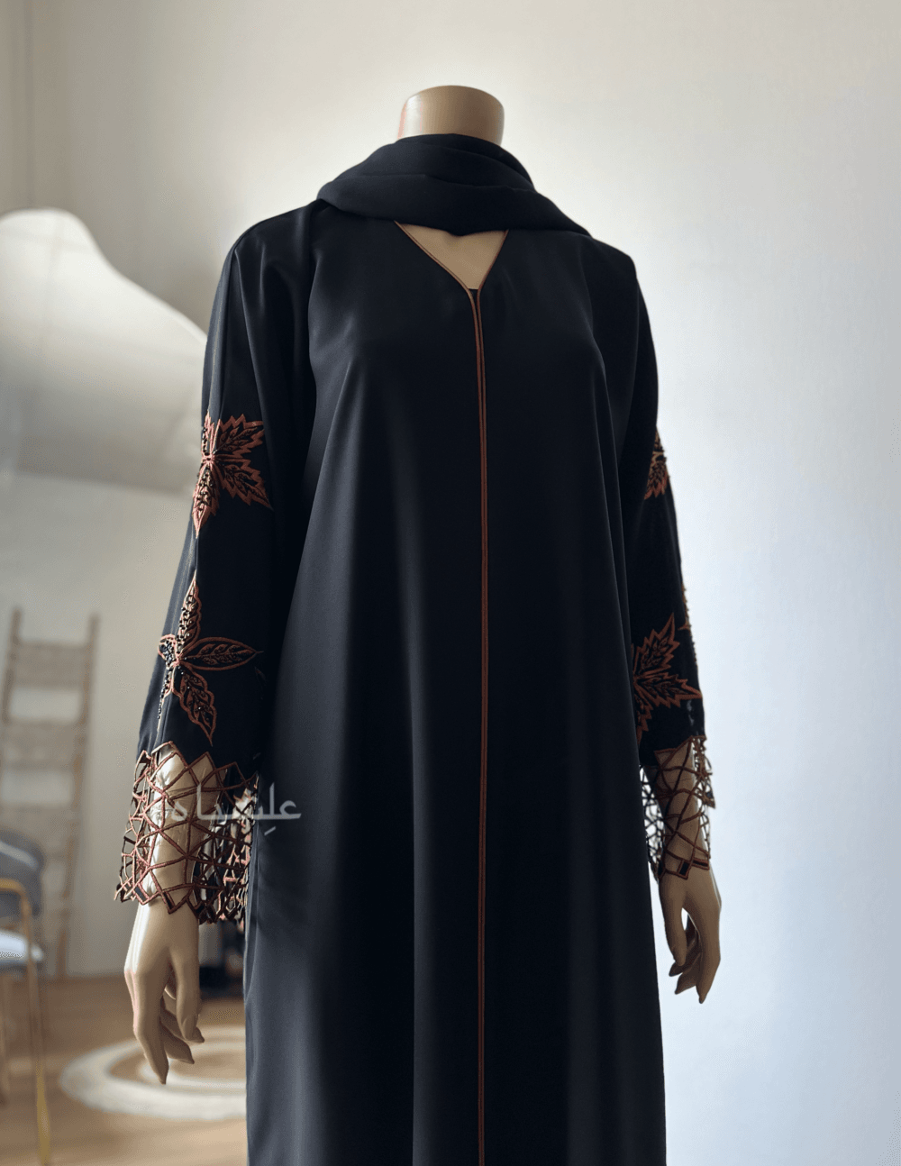 Abaya made from luxurious Nida fabric featuring intricate cutwork embroidery on the sleeves and handwork embellishments on the front panel. The Alishbah Nida Premium Abaya combines elegance and sophistication, offering timeless grace for any occasion.