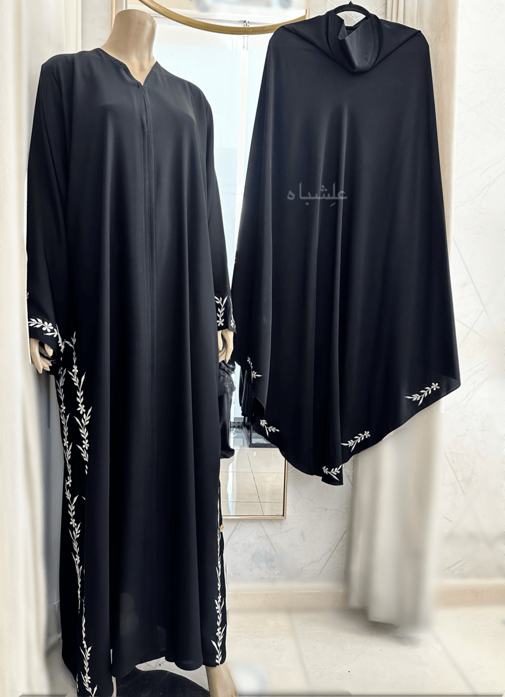 Abaya featuring premium Nida fabric with intricate floral embroidery woven with zari thread, complemented by a luxurious khimar made of Almas fabric. The Alishbah Salafi Khimar Abaya blends timeless elegance with contemporary design, offering sophistication and grace.