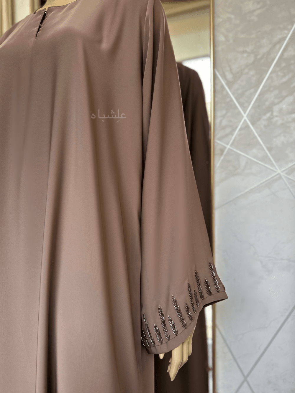 Abaya featuring delicate handwork embellishments on the sleeves and slits, crafted from high-quality materials. The Alishbah Pink Abaya blends timeless elegance with modern sophistication, suitable for both formal and casual occasions."