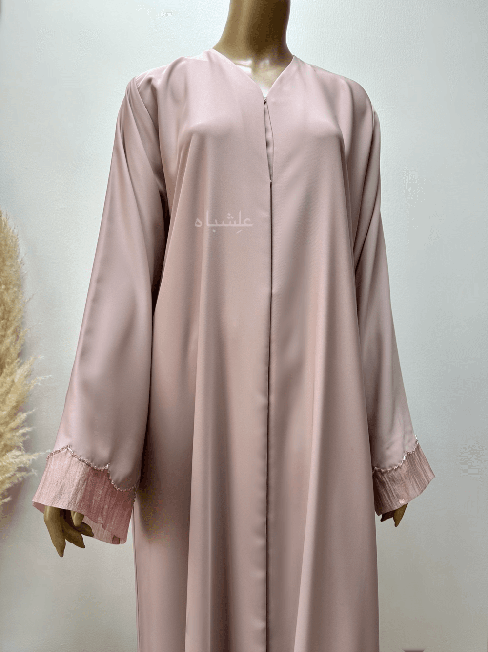 Abaya in pastel pink featuring delicate organza fabric and intricate tube work detailing. The Pastel Pink Abaya by Alishbah offers timeless elegance and sophistication, perfect for both formal events and everyday wear.