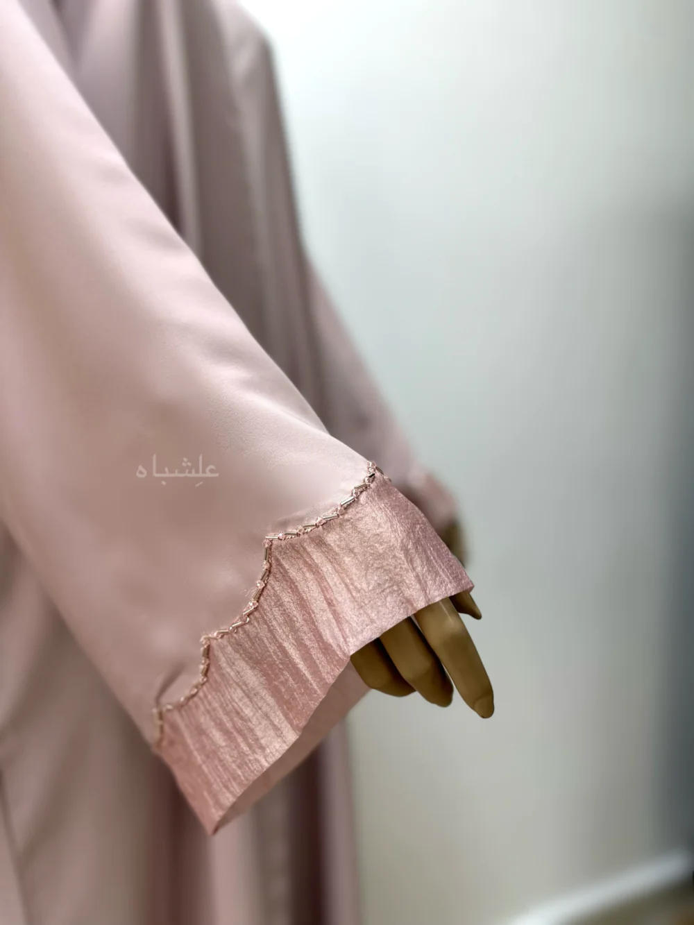 Abaya in pastel pink featuring delicate organza fabric and intricate tube work detailing. The Pastel Pink Abaya by Alishbah offers timeless elegance and sophistication, perfect for both formal events and everyday wear.