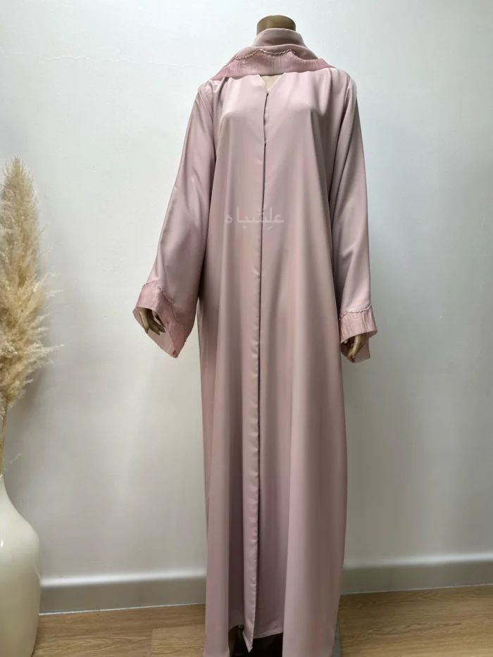 Abaya in pastel pink featuring delicate organza fabric and intricate tube work detailing. The Pastel Pink Abaya by Alishbah offers timeless elegance and sophistication, perfect for both formal events and everyday wear.