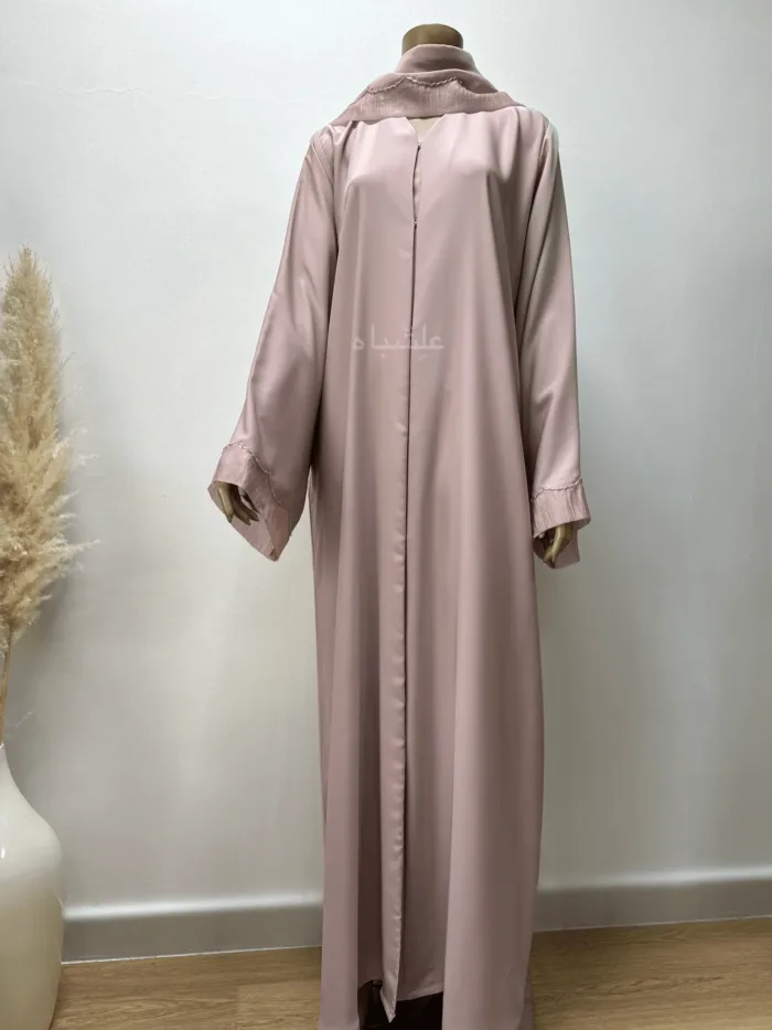 Abaya in pastel pink featuring delicate organza fabric and intricate tube work detailing. The Pastel Pink Abaya by Alishbah offers timeless elegance and sophistication, perfect for both formal events and everyday wear.