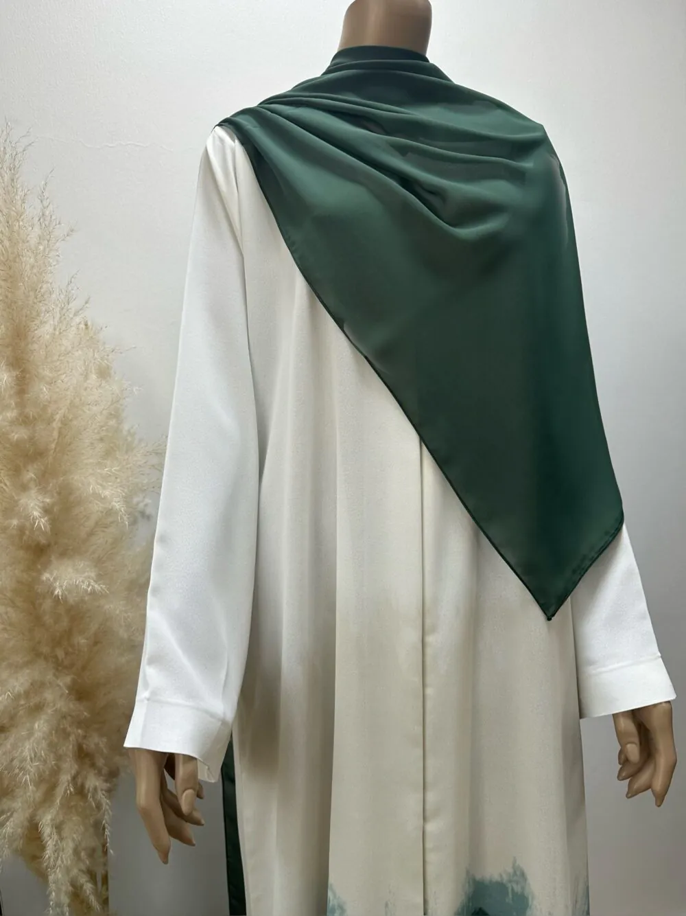 "Front view of the Ombré Abaya by Alishbah, showcasing a gradient color transition from light to dark hues. The luxurious fabric drapes elegantly, creating a flowing silhouette. The Sheila is styled open, enhancing the versatile and timeless sophistication of the abaya."