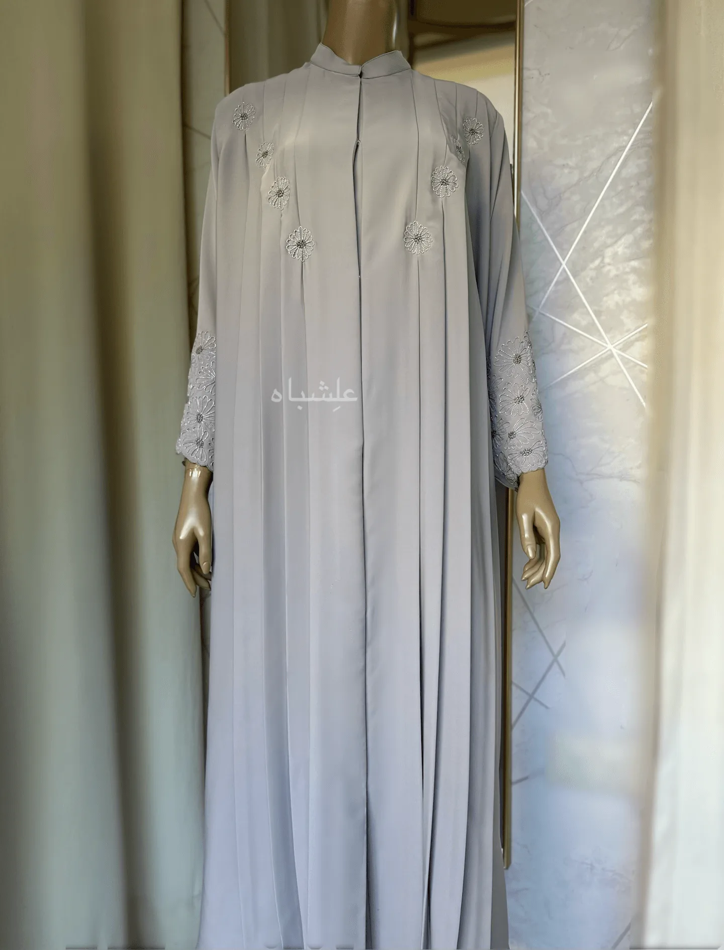 Eternal Petals of Grace Nida Premium Abaya with Floral Handwork 5 Alishbah Eternal Petals of Grace Nida Premium Abaya with floral handwork. The abaya is crafted from luxurious Nida Premium fabric, featuring delicate floral handwork including tiny scallops and French knots that form elegant patterns along the cuffs and neckline. The ensemble is completed with a soft chiffon sheila (headscarf) that drapes gracefully, enhancing the sophisticated and timeless design. This abaya blends traditional handwork with contemporary elegance, showcasing high-quality craftsmanship and refined style.