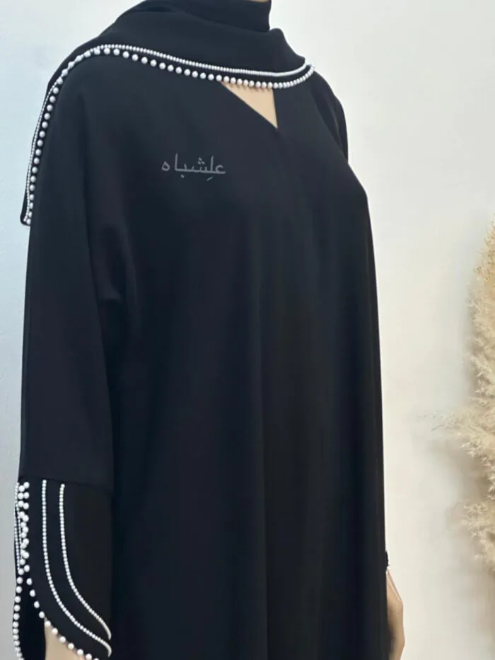 Close-up of Pearl Serenity Abaya from Alishbah, showcasing delicate pearl handwork on soft chiffon Sheila.