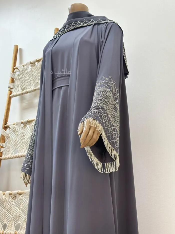 “Blue Egyptian Crape Abaya with Intricate Handwork and Dangling Embellishments.”