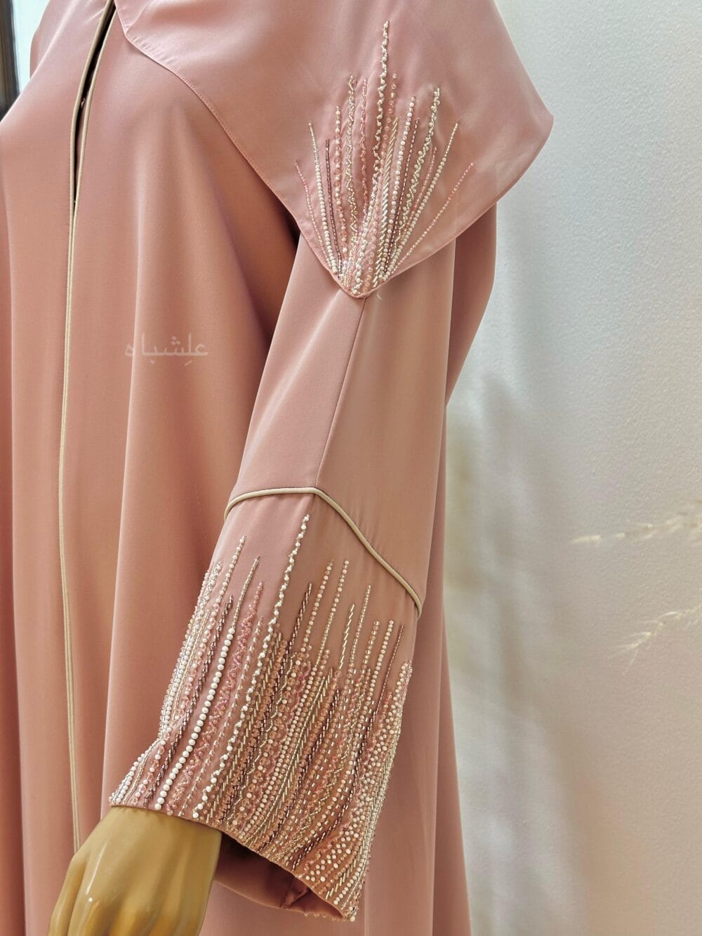 "Roseate Charm Abaya: Soft pink with intricate handwork and detailed piping, exuding timeless sophistication."