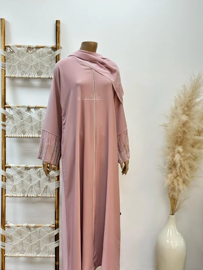 "Roseate Charm Abaya: Soft pink with intricate handwork and detailed piping, exuding timeless sophistication."