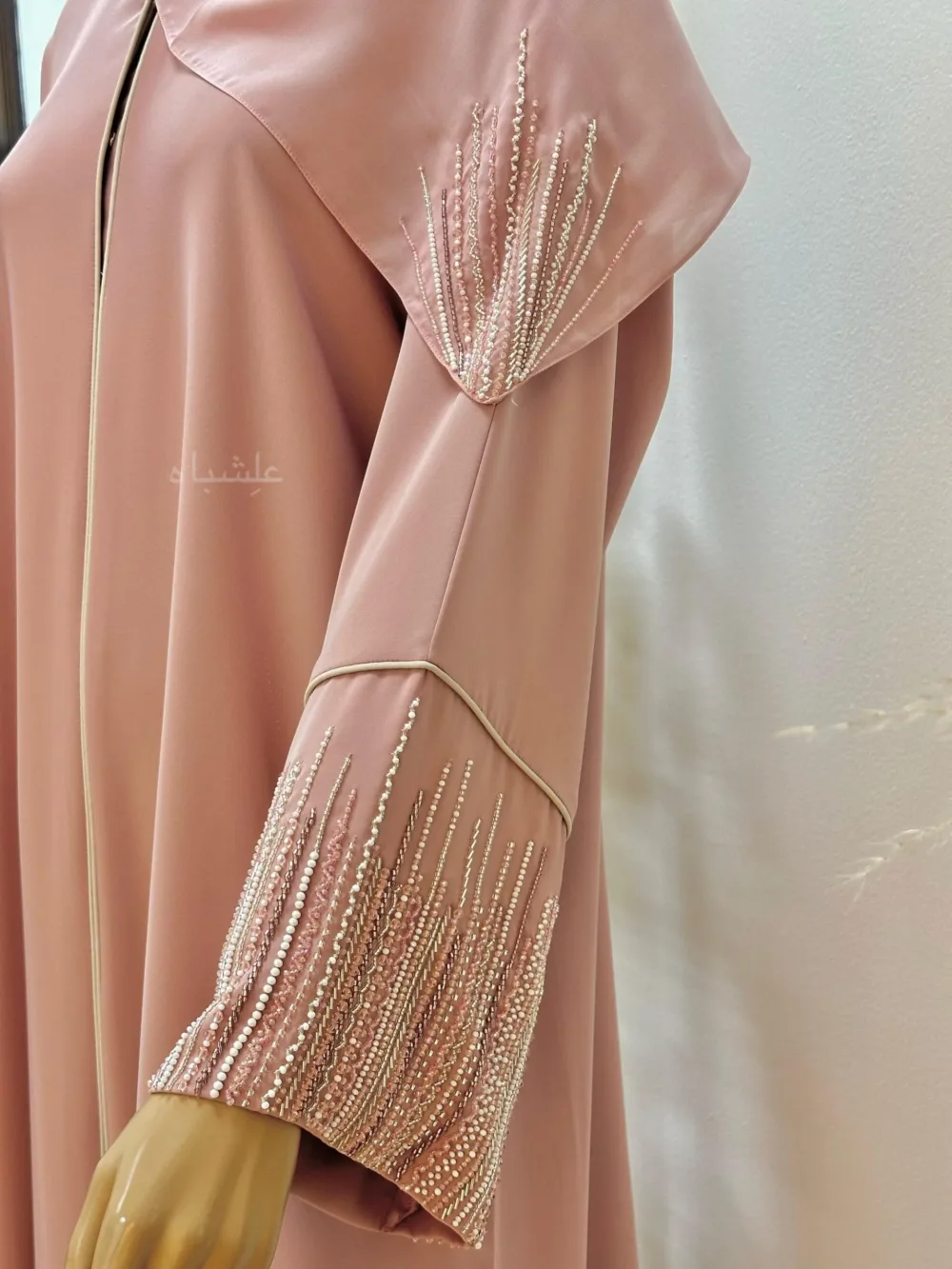 "Roseate Charm Abaya: Soft pink with intricate handwork and detailed piping, exuding timeless sophistication."
