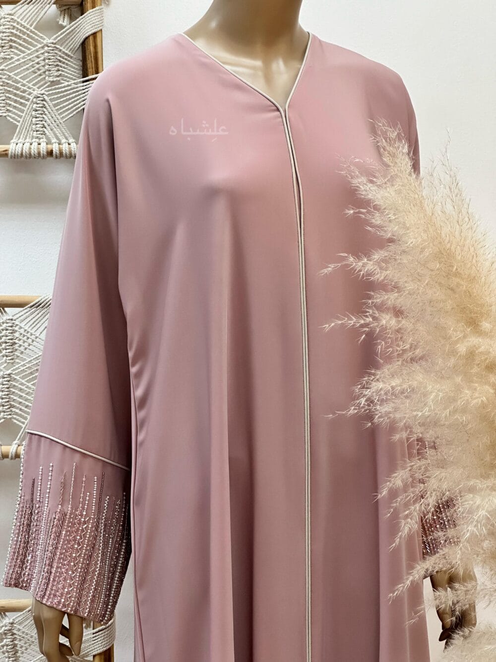 "Roseate Charm Abaya: Soft pink with intricate handwork and detailed piping, exuding timeless sophistication."