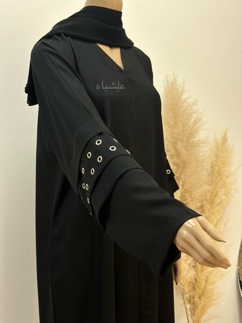 A stylish Korean crape abaya featuring handcrafted button hole embellishments, paired with a soft chiffon Sheila for versatile styling