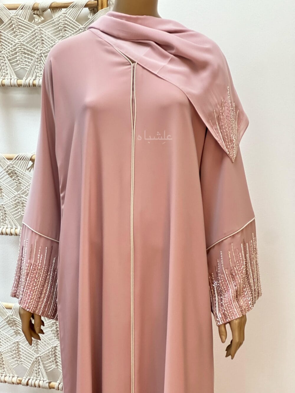 "Roseate Charm Abaya: Soft pink with intricate handwork and detailed piping, exuding timeless sophistication."