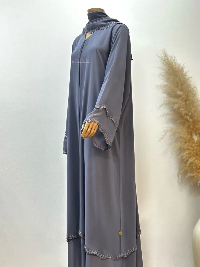 A luxurious chiffon abaya with detailed embroidery and handwork on the sleeves and bottom hem, paired with a matching soft chiffon Sheila for a refined look.