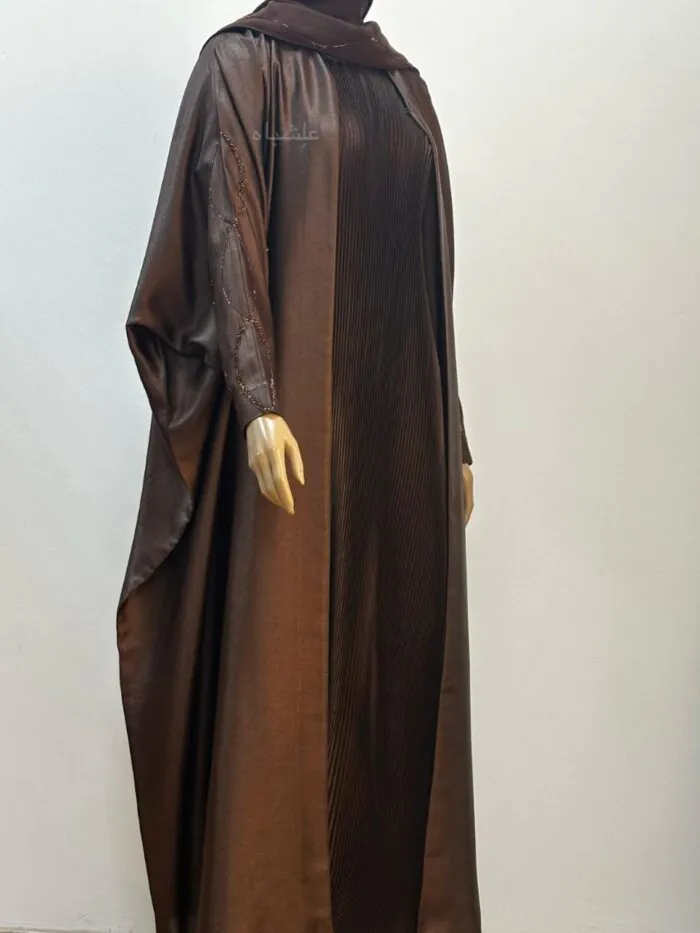 Side view of the Marya Satin Flow Abaya set, featuring a luxurious satin abaya with handworked sleeves, a custom pleated inner dress, and a soft chiffon sheila.