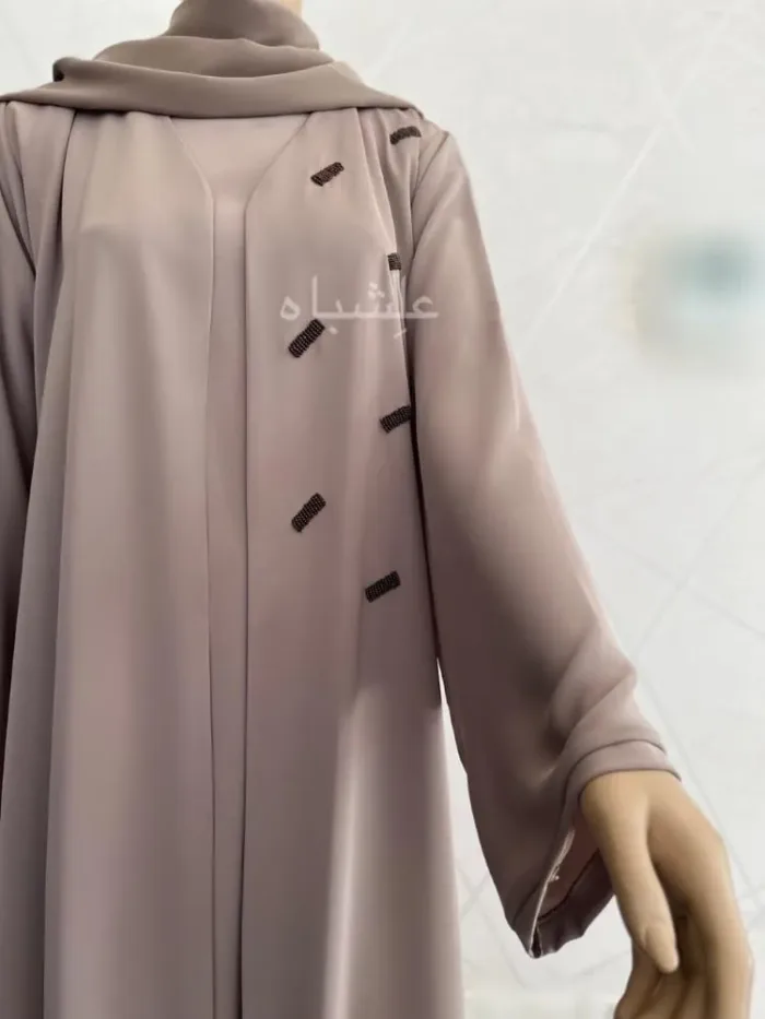Front half view of the abaya with sleeves raised high