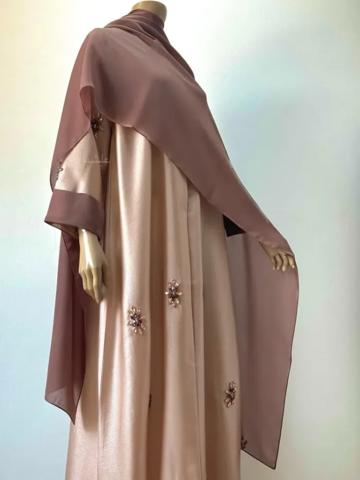 Front side view of the abaya with sheila all over the front with hands slightly raised higher
