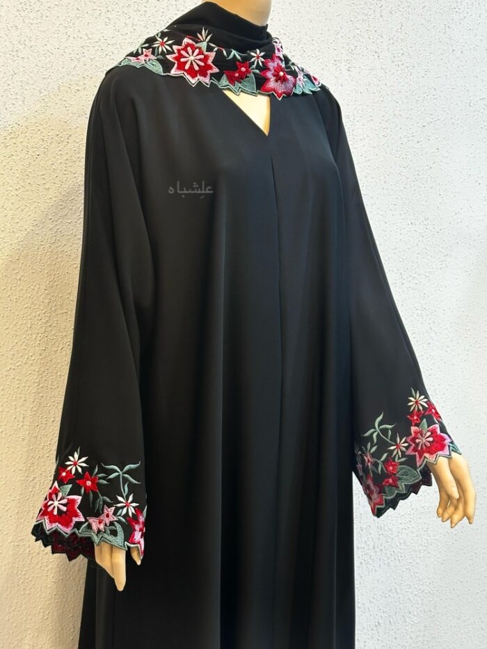 Front close up view of abaya with hands raised little higher showing the embroidery on sleeves and sheila