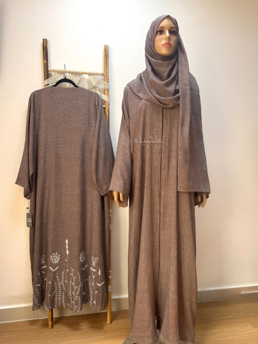 Front view of abaya with sheila and sample on ladder