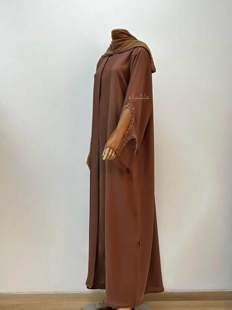 Pearl Glow Abaya 4 Front full view of abaya with sheila with one hands raised
