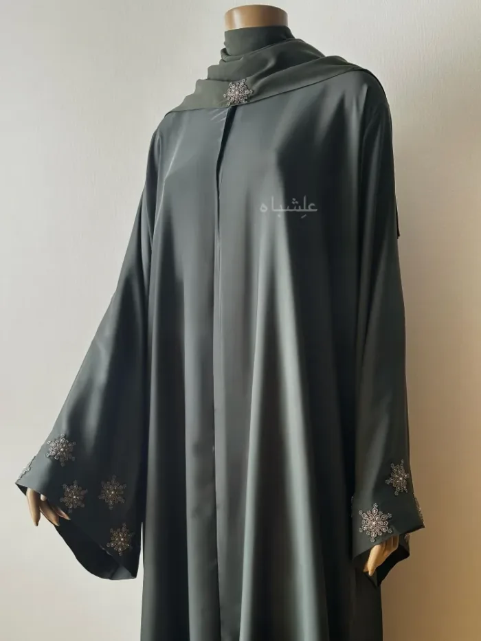 Front view of abaya with sheila one hand slightly raised higher