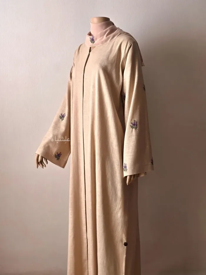 front view of abaya with one hand raised higher