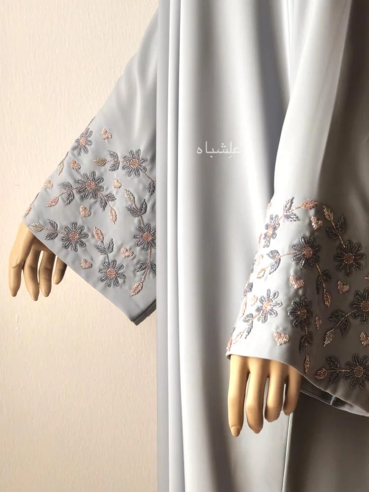 Close up view of both sleeves in pastel blue abaya showing the handwork