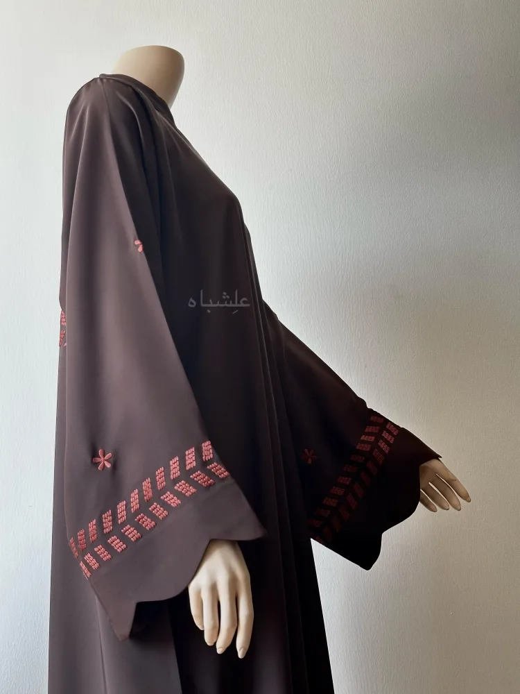 Maroon Mosaic Abaya 3 Side view of abaya without sheila one hand raised higher
