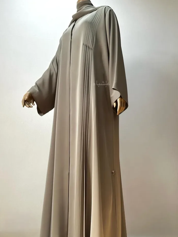 Front view of abaya from a different angle with one hand raised higher