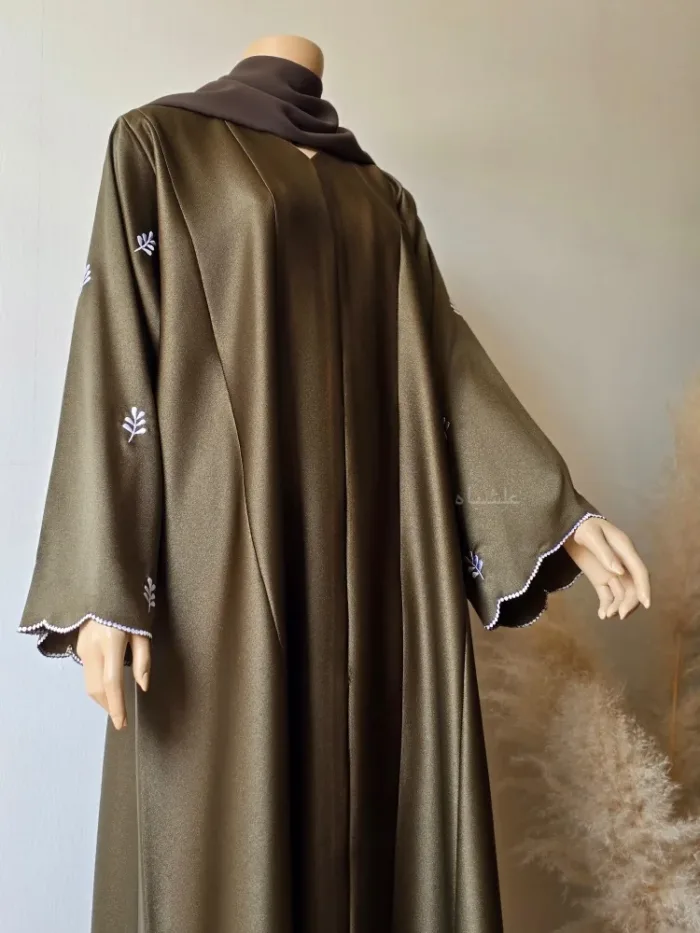 Front close-up view of abaya with one hand raised