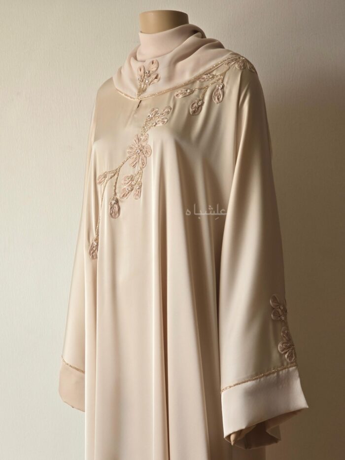 Front kind of a side view of abaya with sheila showing the work on the front of the abaya and the work on the sheila