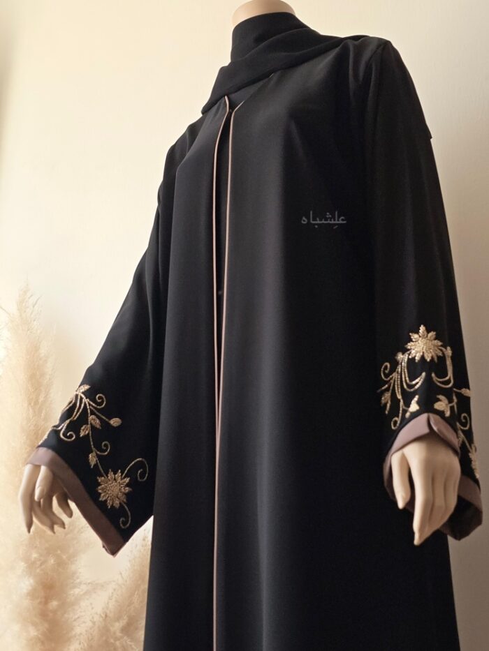 Front close-up view of abaya with sheila with one hand raised higher