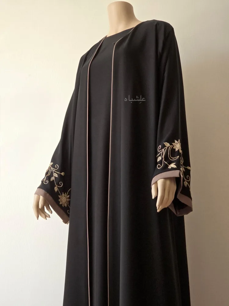 The Taupe Bloom – Black Abaya 3 Front close-up view of abaya without sheila with one hand raised higher