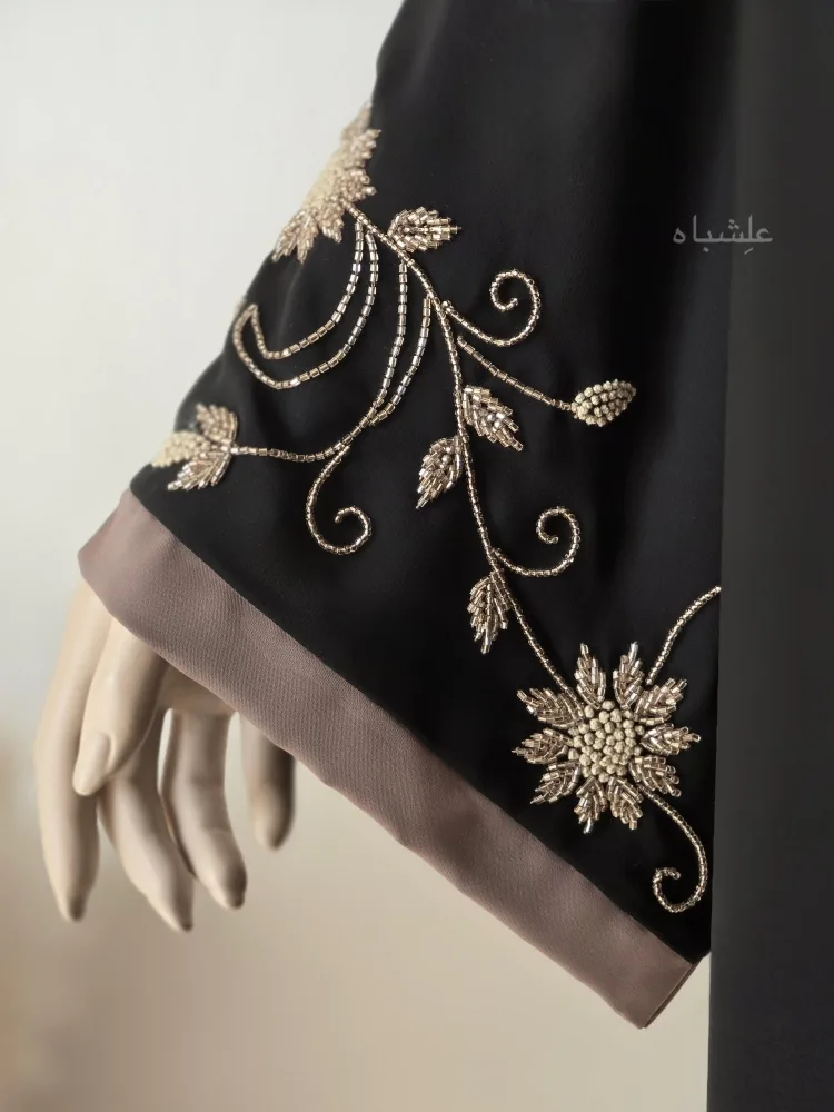 The Taupe Bloom – Black Abaya 5 Close-up view of sleeves from a side showing the handwork