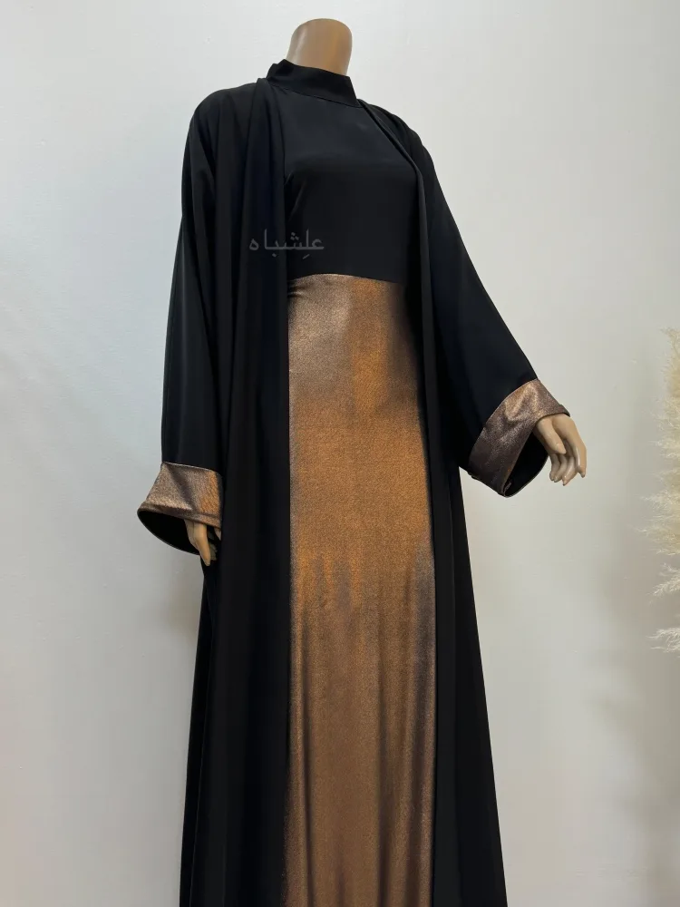 Front view of the abaya with one hand raised higher