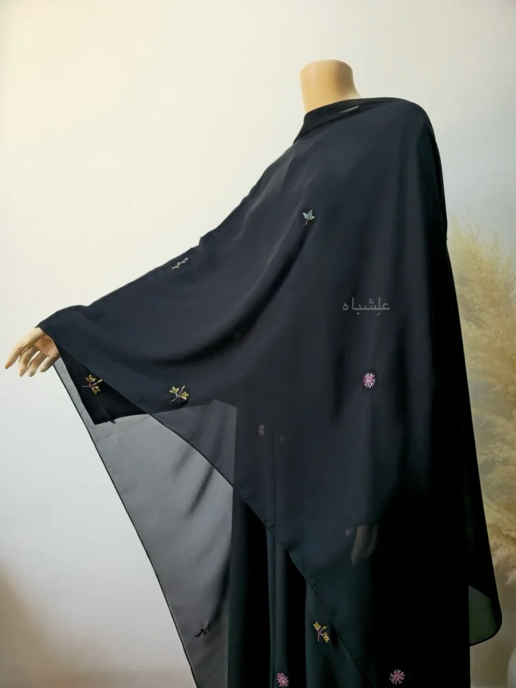 ๐ธ Petal Whisper โ Floral Handwork Abaya by Alishbah Abaya 4 Front view of the abaya with one hand raised higher with sheila spread all over showing the work on all over ssheila