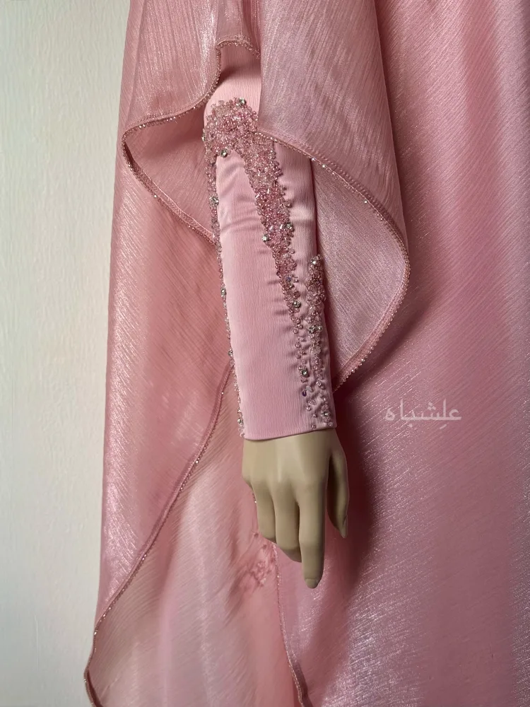 Close-up view of sleeves showing the arc type handwork and close up lining on the end of cape