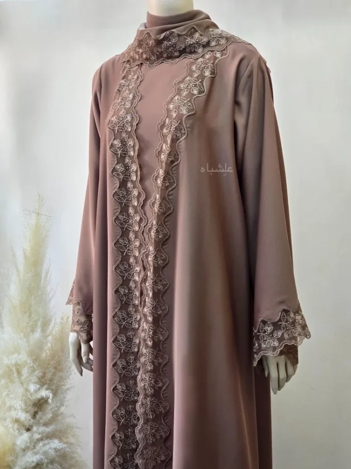 Front close up view of the abaya with sheila showing the lace work on the front and sheila shortside work in detail