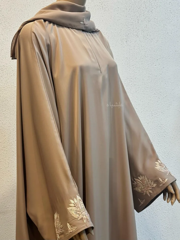 Zaraafah Leaf Abaya by Alishbah 2025 1 Front close up view of abaya with 2 hands raised