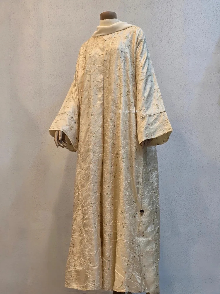 Garden of Layali – Champagne Gold Abaya by Alishbah 3 Front view of abaya with sheila with one hand raised higher