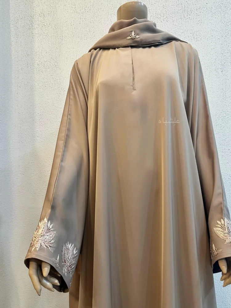 Zaraafah Leaf Abaya by Alishbah 2025 3 Close up front view of abaya with sheila one hand raised
