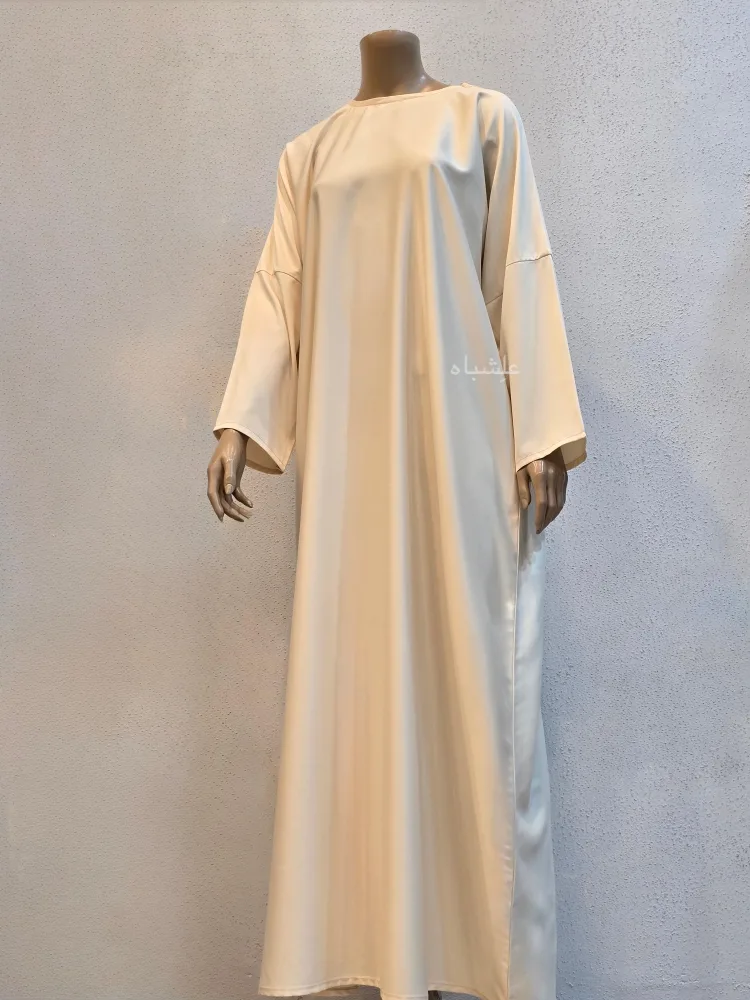 Garden of Layali – Champagne Gold Abaya by Alishbah 5 Front view one inner abaya with one hand raised higher