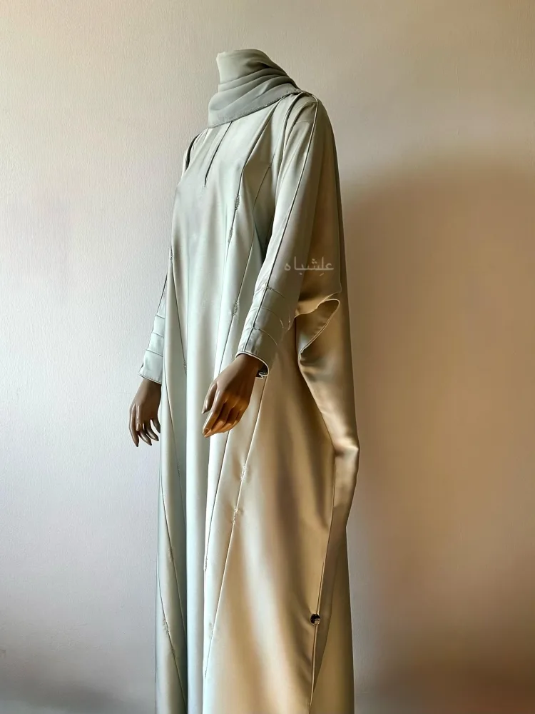 Best Abaya Colors for Different Skin Tones (Europe, USA & Global Guide) 19 Front full view of abaya with sheila from a different angle with one hand raised higher