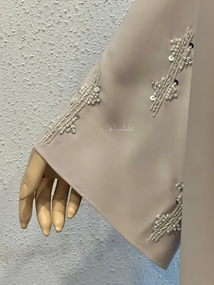 Close up view of  sleeves of beige abaya