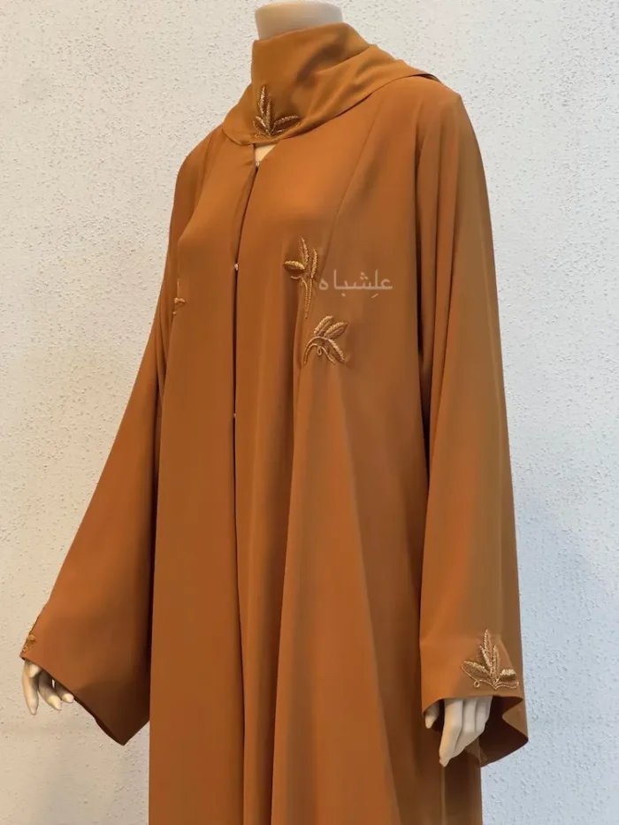 Home 6 Amber Leaf Egyptian Crape Abaya front close-up View with one hand raised