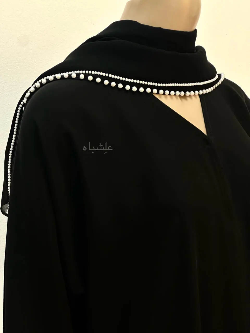 Close-up of Pearl Serenity Abaya from Alishbah, showcasing delicate pearl handwork on soft chiffon Sheila.