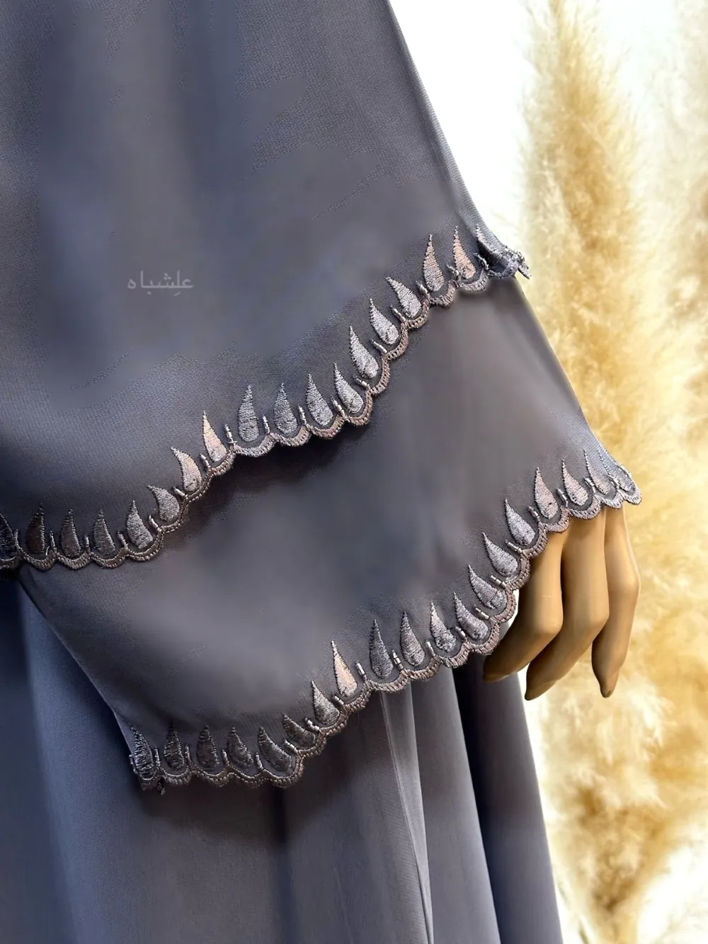 Ultra Close up view of A luxurious chiffon abaya with detailed embroidery and handwork on the sleeves